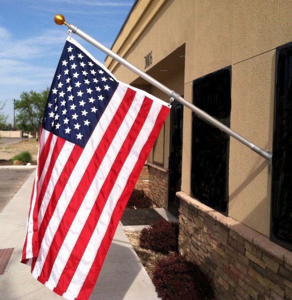 Wall-mounted pole and flag not lowered